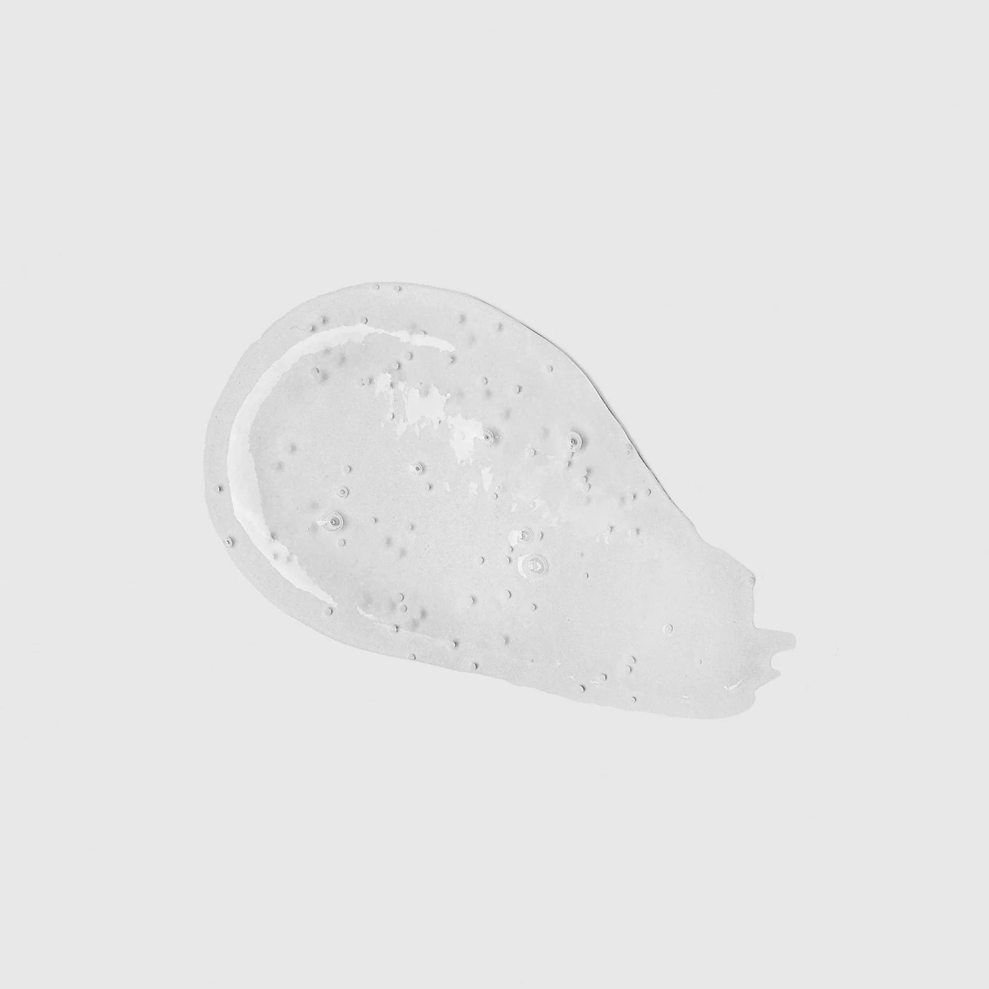 White cream or gel with visible texture on a light gray background