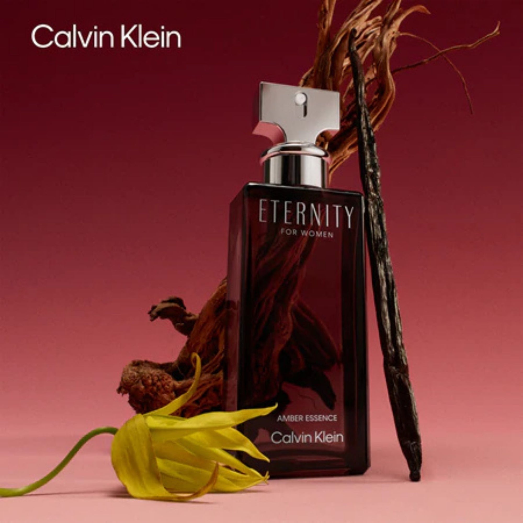 Calvin Klein Eternity perfume bottle with dried flowers on a red background
