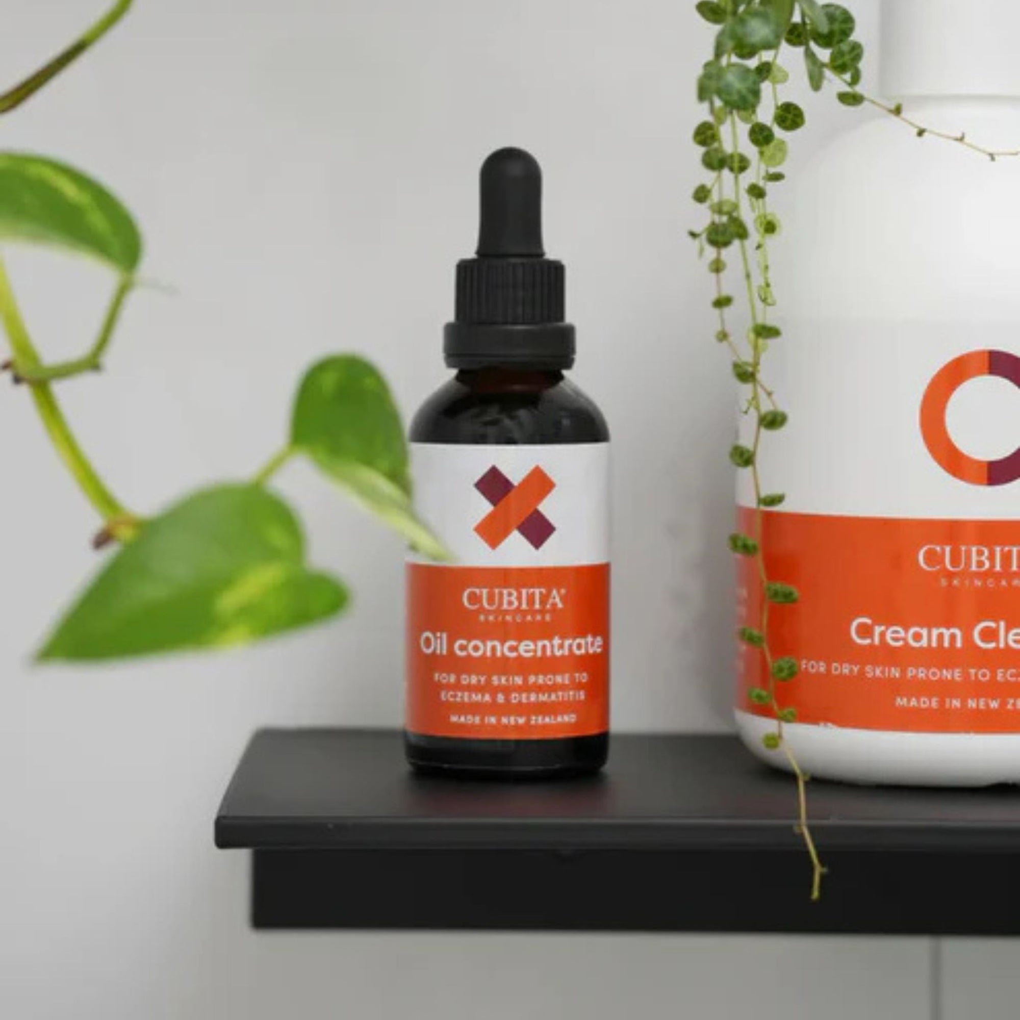 Cubita skincare products on a shelf with plants in the background
