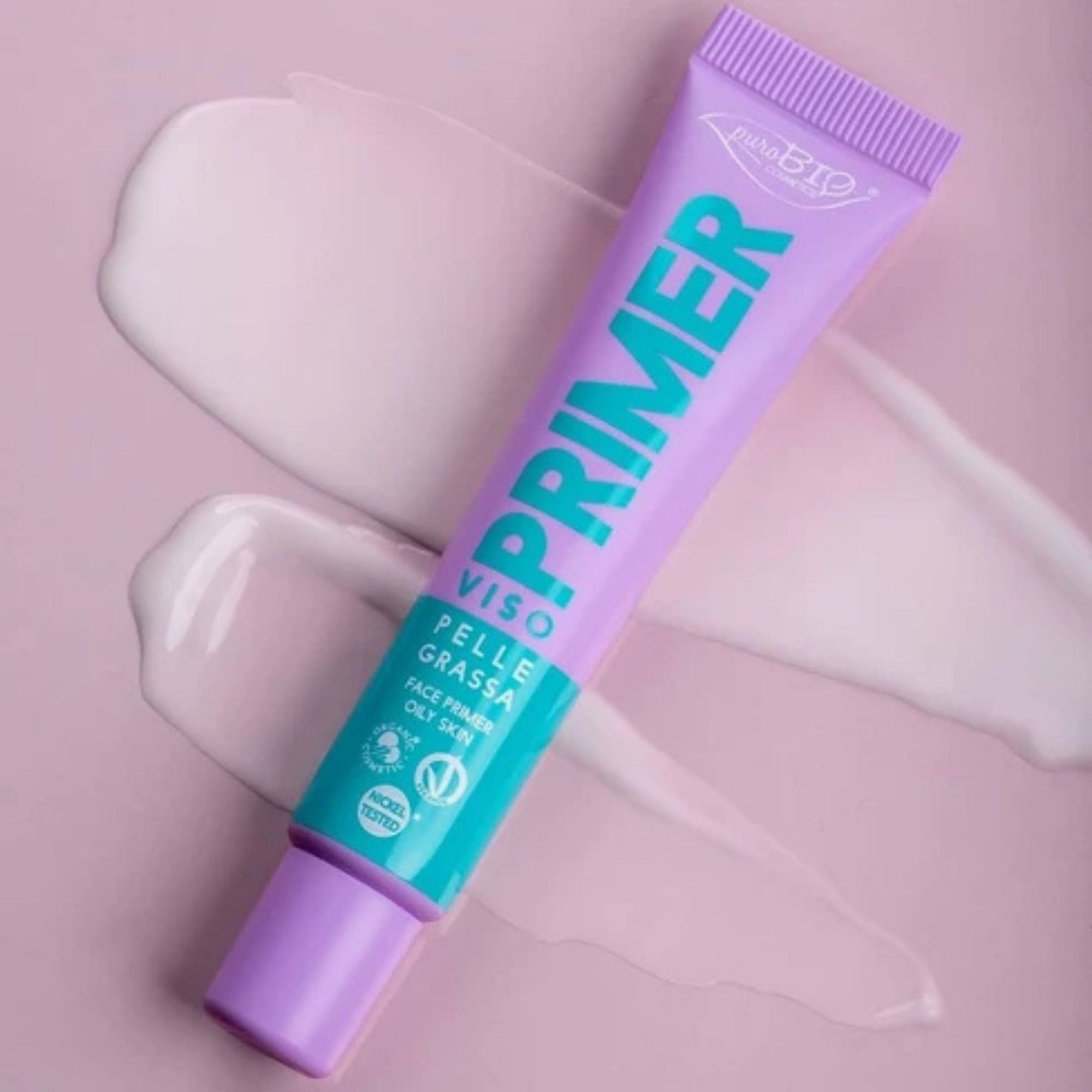 PuroBIO Face Primer – Oily Skin Fluid on pink background showing the primer smudged across it